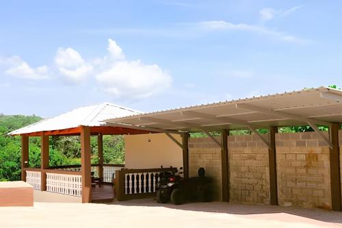 a pavilion with a roof on a patio at Apart Hotel Costa Verde - #2 Exclusivo y Seguro cama King zise in Las Galeras