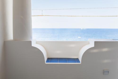 a bathroom with a view of the ocean from a building at Archi Suite Canneto in Canneto