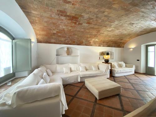 a living room with white couches and a brick wall at Casa BlauBegur - ref 056 in Begur