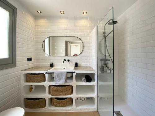 a white bathroom with a sink and a mirror at Casa BlauBegur - ref 056 in Begur