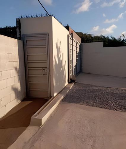 a door in the side of a white building at Apart hotel Costa Verde #3 Exclusivo y Seguro in Santa Bárbara de Samaná