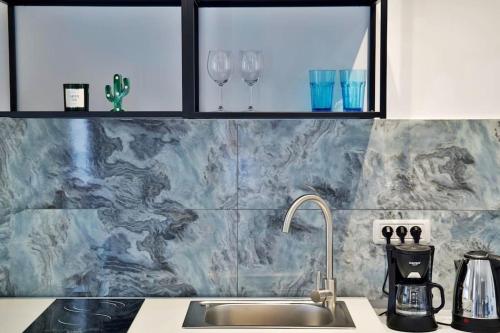 a kitchen with a sink and two wine glasses at Bulldog Studio in Năvodari