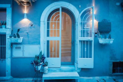 a blue building with a door and a window at VenuSuite VENOSA - Luxury House, Spa & Relax - in Venosa