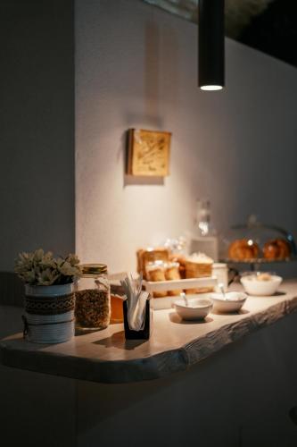 a table with a bunch of bread and dishes on it at VenuSuite VENOSA - Luxury House, Spa & Relax - in Venosa