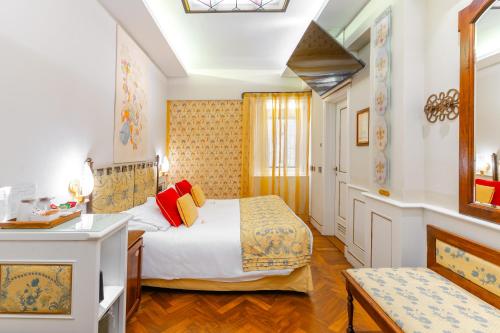a hotel room with a bed and a desk at Art Hotel Commercianti in Bologna
