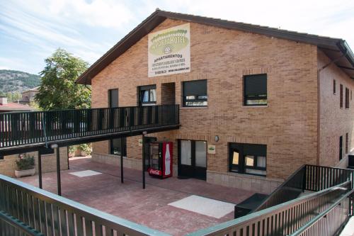 an outside view of a building with a vending machine at Apartahotel Rural CollaRubio Luxury in Collado Mediano