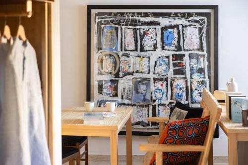 a dining room with a table and a wall of plates at MOB HOTEL Cannes in Cannes