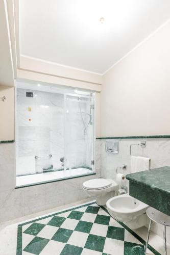 a bathroom with a toilet and a sink and a shower at Art Hotel Commercianti in Bologna