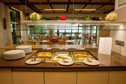 a buffet with plates of food on a table at Haus Maria Lindenberg in Sankt Peter