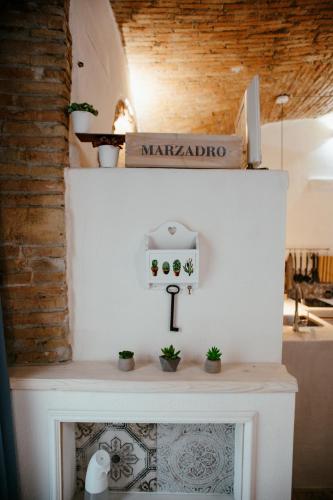 a fireplace with plants on top of it at VenuSuite VENOSA - Luxury House, Spa & Relax - in Venosa