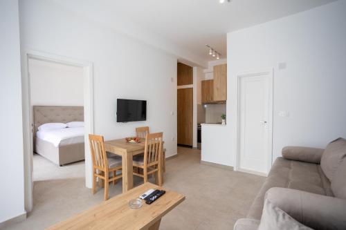 a living room with a couch and a table at Apartmani Milos - Meljine in Herceg-Novi