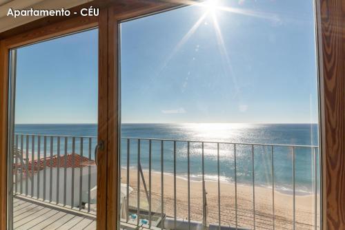 a balcony with a view of the beach at Season Apartments in Sesimbra