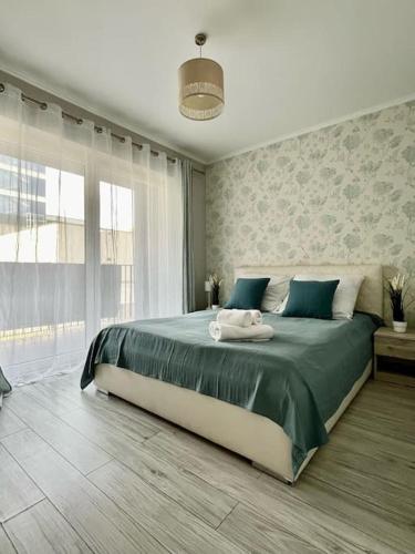 a bedroom with a large bed with blue pillows at EASY RENT- Nice, Centrum, 24h Check-in in Lublin