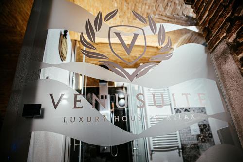 a sign for a luxury house with a logo at VenuSuite VENOSA - Luxury House, Spa & Relax - in Venosa