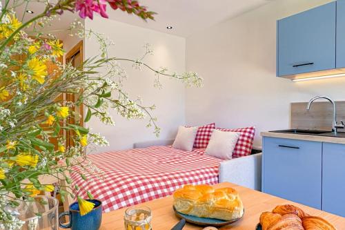 a kitchen with a table with some bread on it at Studio Le Nid Douillet in Passy