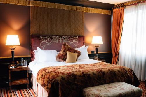 a hotel room with a large bed and two lamps at The Merchant Hotel in Belfast