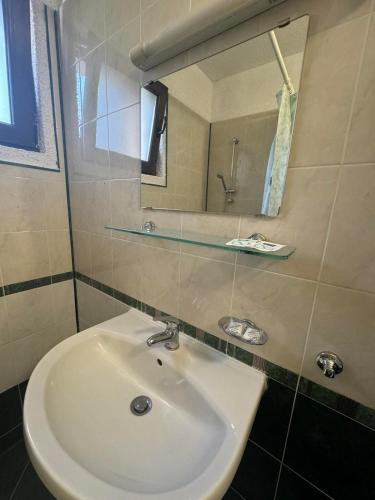 a bathroom with a sink and a mirror at Villa Rila Borovets with Hot Pool, Jacuzzi & Sauna by BookVillaBG in Borovets