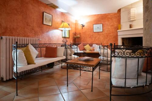 a living room with a couch and a table at Logis Hôtels - Hôtel Restaurant Domaine Les Falaises in Martel