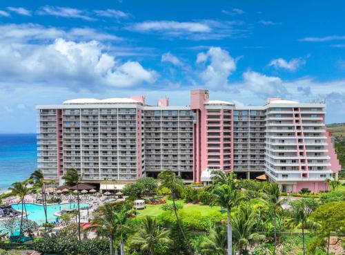 a large pink hotel with a pool and the ocean at Hilton Vacation Club Ka'anapali Beach Maui in Kaanapali