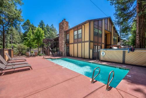 a house with a swimming pool in front of a house at Best Western Stagecoach Inn in Pollock Pines