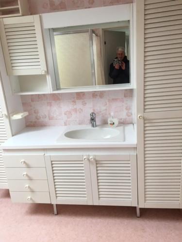 a person taking a picture of a bathroom sink at Stora Skedvi in Stora Skedvi