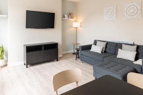 a living room with a couch and a tv at Host & Stay - The Quarter in Liverpool