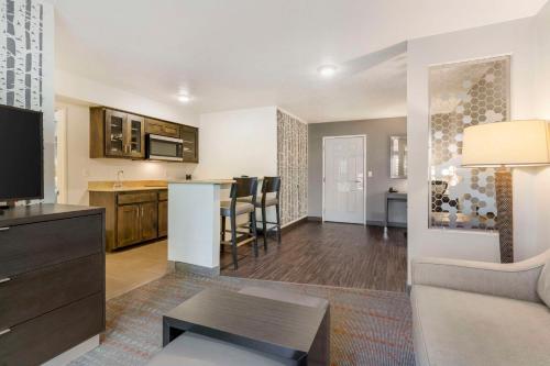 a living room and kitchen with a couch and a table at Best Western Corvallis in Corvallis