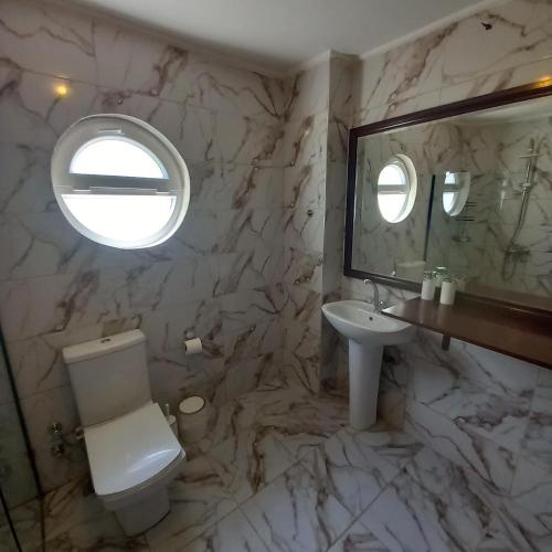 a bathroom with a toilet and a sink and a mirror at Villa ZEYNO in Kaş