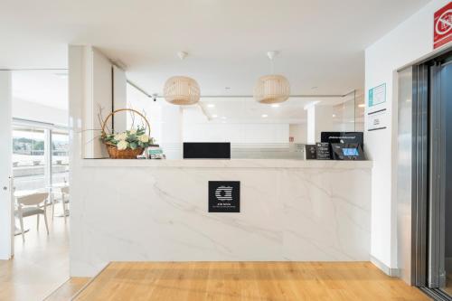 a kitchen with white walls and a counter top at Hotel Alda Vía Norte in O Grove