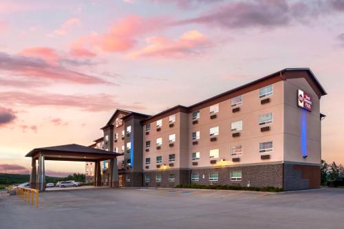 a rendering of a hotel with a parking lot at Best Western Plus Peace River Hotel & Suites in Peace River