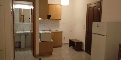 a small kitchen with a sink and a refrigerator at Anna's Apartment 1 - Cozy stay for 3 in Lixouri in Lixouri