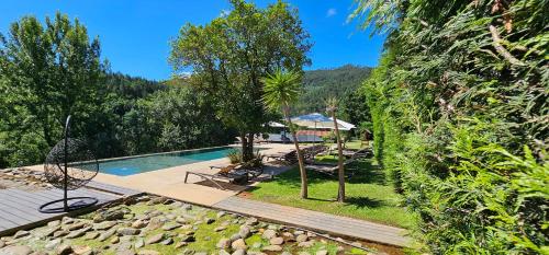 a resort with a swimming pool and a garden at Rio Moment's in Castelo de Paiva