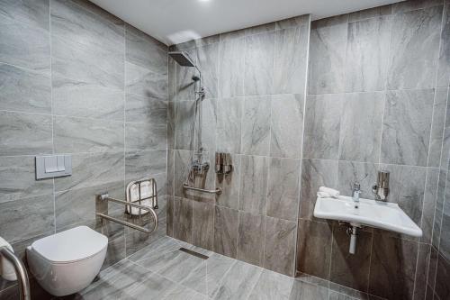 a bathroom with a toilet and a sink at Best Western Plus Batumi in Batumi