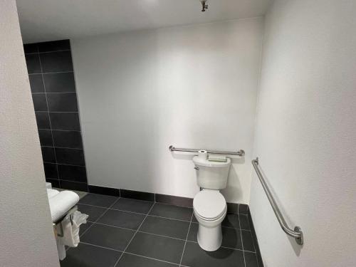 a bathroom with a toilet and a sink at The Midtowner Hotel, SureStay Collection by Best Western in Sacramento