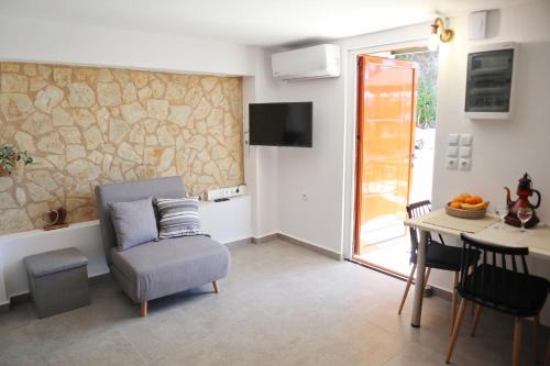 a living room with a chair and a table at Arokaria Studio in Paralion astros