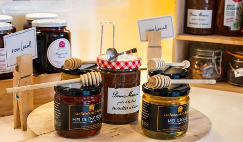 four jars of honey on a shelf in a store at ibis Dijon Gare in Dijon