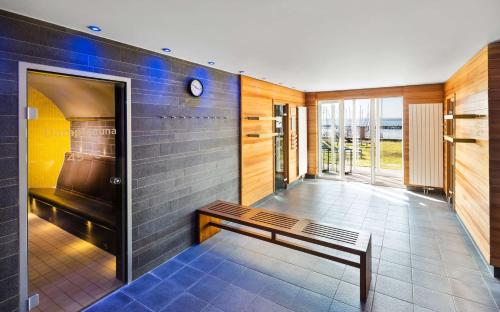 a hallway with a bench in a room at Lindner Hotel Boltenhagen, part of JdV by Hyatt in Boltenhagen