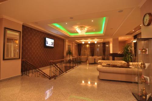 a living room with a green light on the ceiling at Hotel Megalos in Constanţa