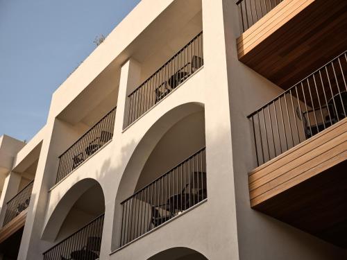 a building with balconies on the side of it at Planos Deluxe in Zakynthos Town