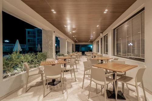 a row of tables and chairs in a restaurant at Planos Deluxe in Zakynthos Town