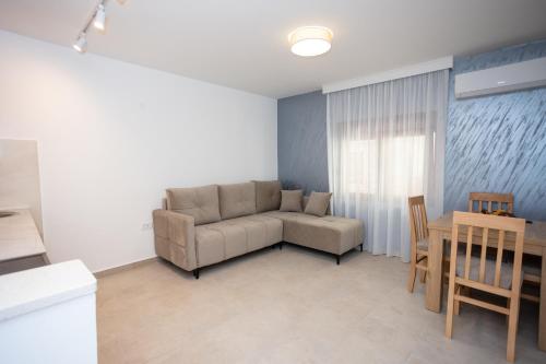 a living room with a couch and a table at Apartmani Milos - Meljine in Herceg-Novi