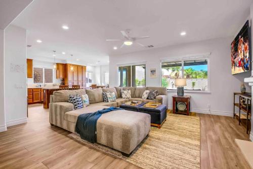 a living room with a couch and a table at SPLASH-TASTIC FUN HOUSE in Indio