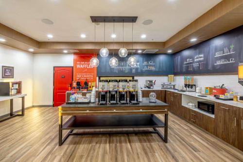 a bar in a restaurant with a red refrigerator at Hampton Inn & Suites Cleburne in Cleburne