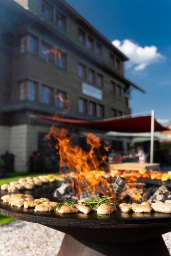 a grill with a bunch of food on fire at Hotel Oddech in Pec pod Sněžkou