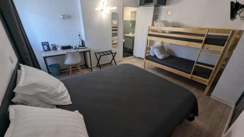 a bedroom with two bunk beds and a desk at Hôtel Aragon - Centre ville gare in Perpignan
