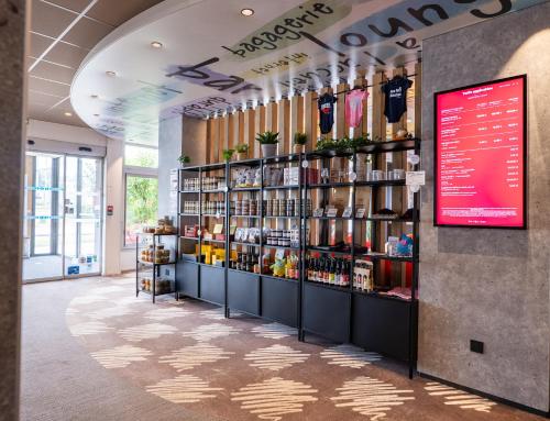 a store with a display of products on shelves at ibis Dijon Gare in Dijon