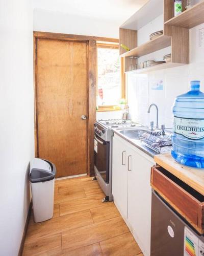 a kitchen with a large bottle of water on the counter at Cabañas Alto Rincon de Atacama in El Barquito
