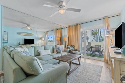 a living room with a couch and a tv at Perdido Dunes 21 by Vacation Homes Collection in Orange Beach