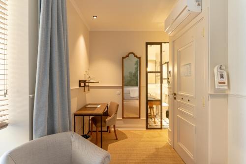a living room with a table and a mirror at AlmaLusa Alfama in Lisbon