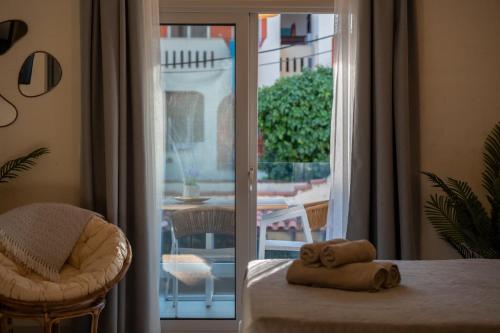 a room with a table and a chair and a window at IOSIF LUXURY ROOMS CENTER in Neos Marmaras